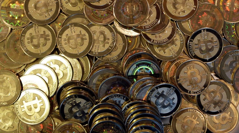 FILE - Bitcoin tokens are seen on April 3, 2013, in Sandy, Utah. (AP Photo/Rick Bowmer, File)