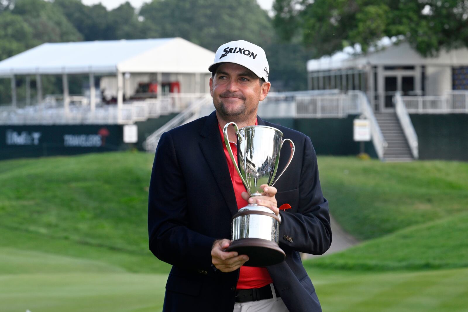 Keegan Bradley holds the championship trophy after winning the Travelers Championship golf tournament at TPC River Highlands, Sunday, June 22, 2025, in Cromwell, Conn. (AP Photo/Jessica Hill)