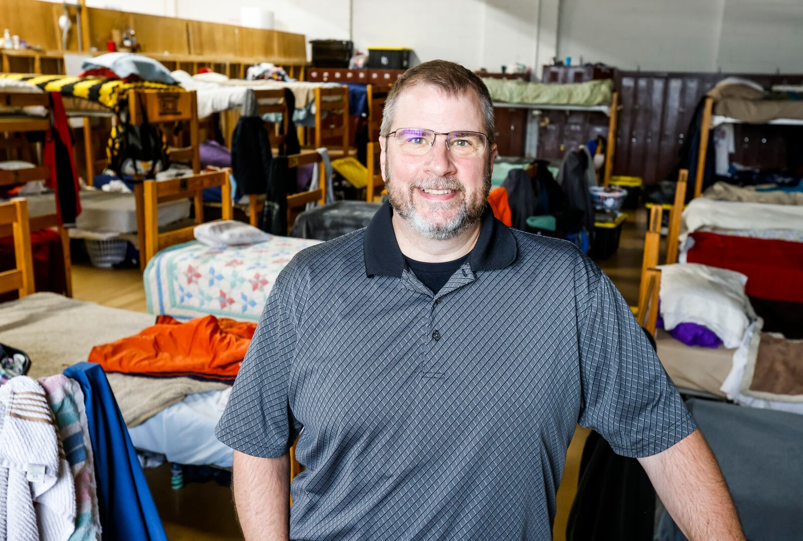 David Hood, executive director of Serve City, stands in their residential shelter on East Avenue in Hamilton. Serve City offers several programs to serve homeless and low-income individuals and families in the area. NICK GRAHAM / STAFF