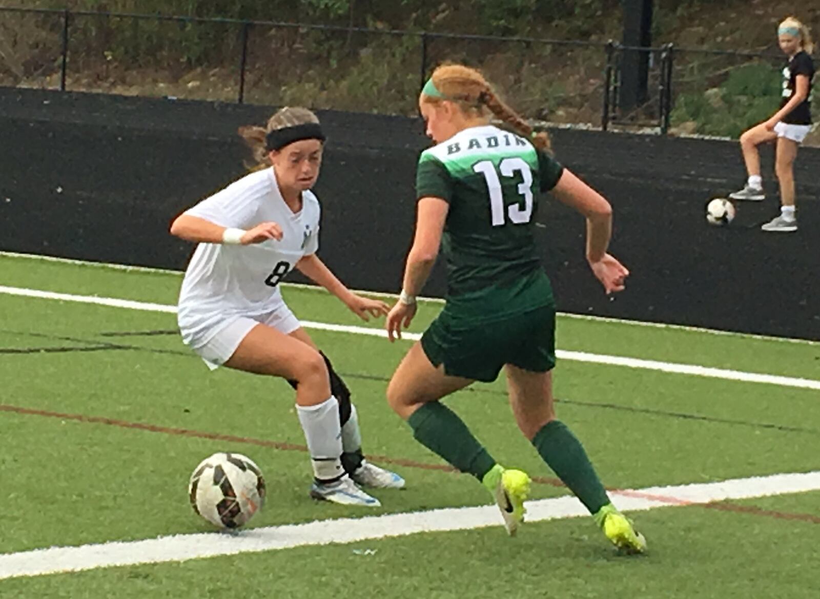 Badin’s Emily Ward (13) battles Nadia Bentley (8) of McNicholas during Wednesday night’s game at Penn Station Stadium in Cincinnati. RICK CASSANO/STAFF