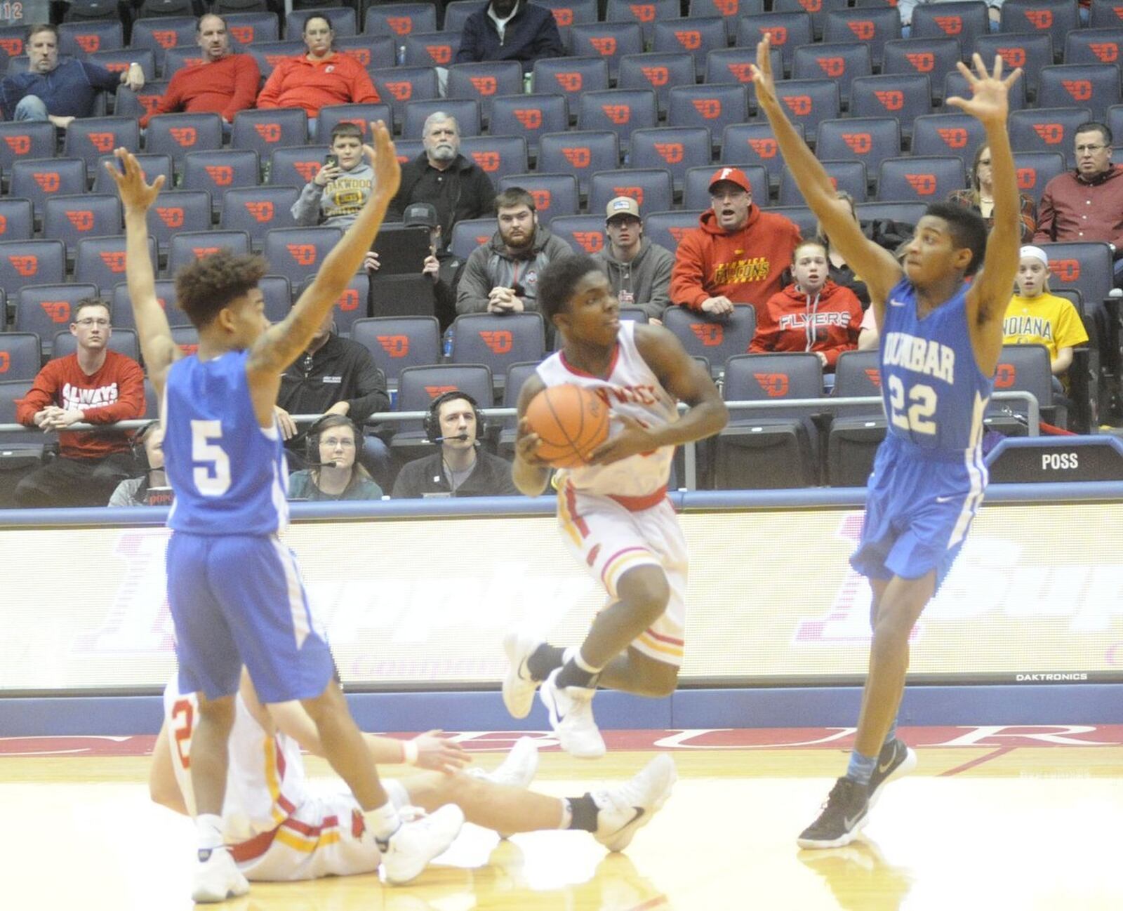 Fenwick’s Caleb Davis (0) can’t get a shot off before the final buzzer as Dunbar’s Kadar Gardner (5) and DaShaun Huffman (22) defend Wednesday night at the end of a Division II sectional final at the University of Dayton Arena. MARC PENDLETON/STAFF