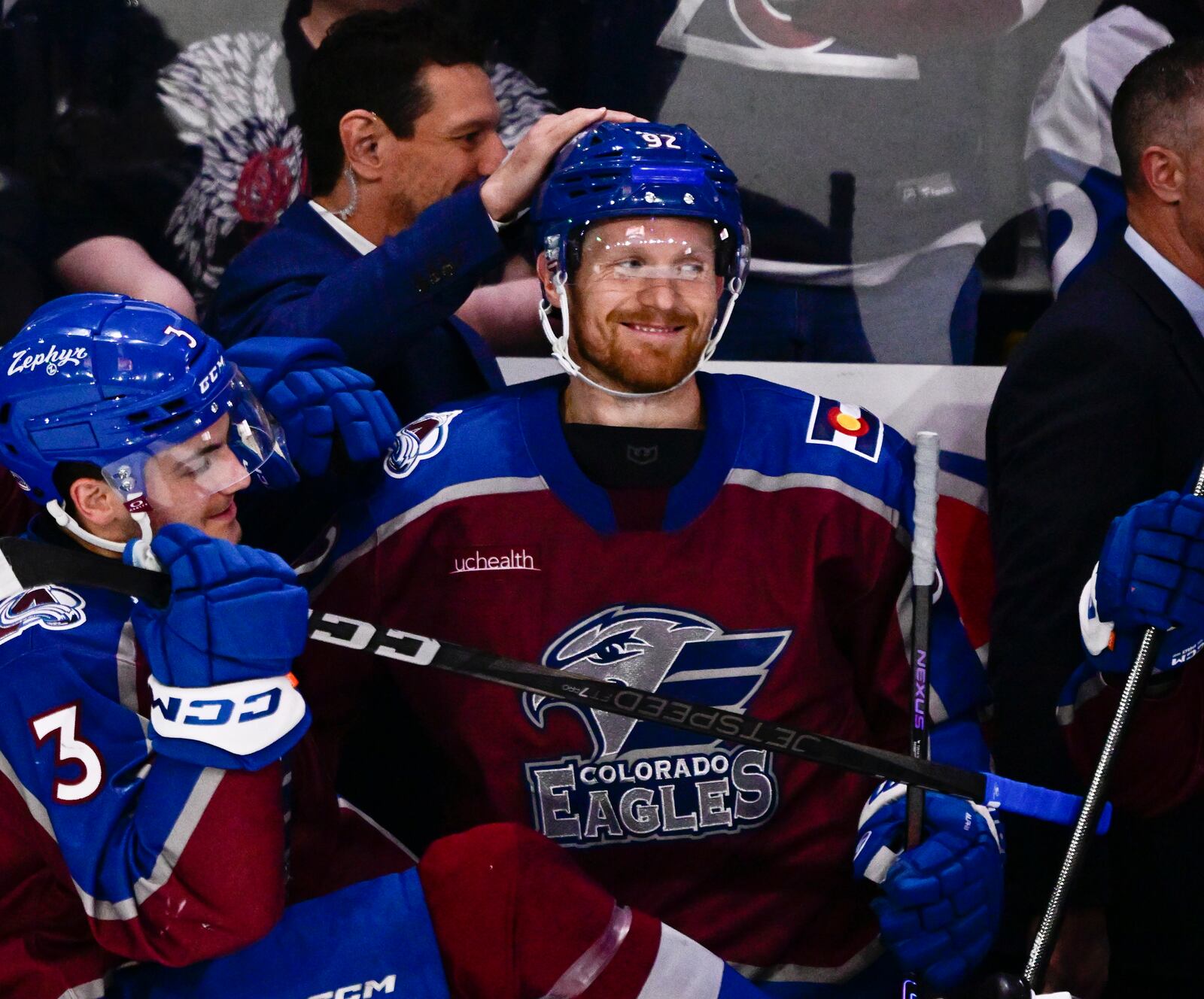 Colorado Eagles forward Gabriel Landeskog, center, gets a pat on the head from assistant head coach Dan Hinote after a minor league hockey game Friday, April 11, 2025, in Loveland, Colo. (Andy Cross/The Denver Post via AP)