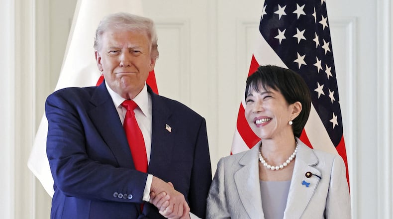 President Donald Trump, left, and Japanese Prime Minister Sanae Takaichi shake hands before their summit talk at Akasaka Palace in Tokyo, Tuesday, Oct. 28, 2025. (Kyodo News via AP)