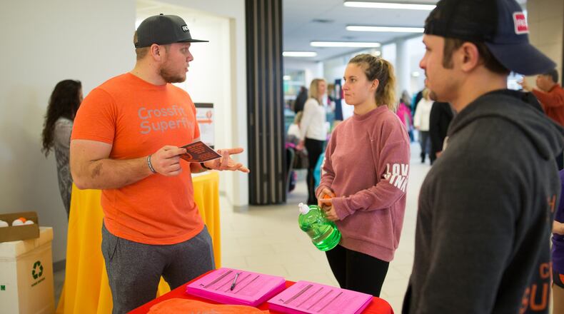 Trainers from CrossFit Superfly answer questions about functional fitness during a vendor fair at Countryside YMCA. CONTRIBUTED