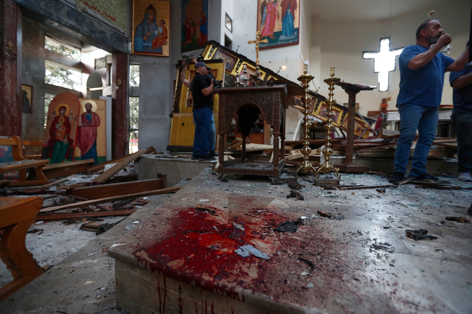 Syrian gather inside Mar Elias church where a suicide bomber detonated himself in Dweil'a in the outskirts of Damascus, Syria, June 22, 2025. (AP Photo/Omar Sanadiki)