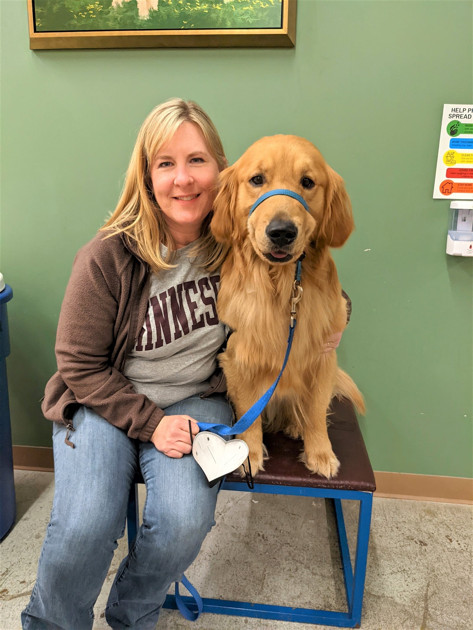 In this photo from 2022, provided by Helping Paws of Eden Prairie, Minn., state Rep. Melissa Hortman, DFL-Brooklyn Park, poses with Gilbert, a golden retriever trained to be a service dog but eventually adopted by the Hortman family, at a training facility in Hopkins, Minnesota. (Helping Paws via AP)