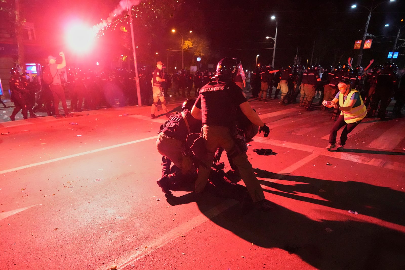 Riot police detain a man after charging protesters at the end of an anti-government rally pressing for an early election after nearly eight months of almost daily anti-corruption demonstrations that have shaken the populist government of President Aleksandar Vucic, in Belgrade, Serbia, Saturday, June 28, 2025. (AP Photo/Darko Vojinovic)