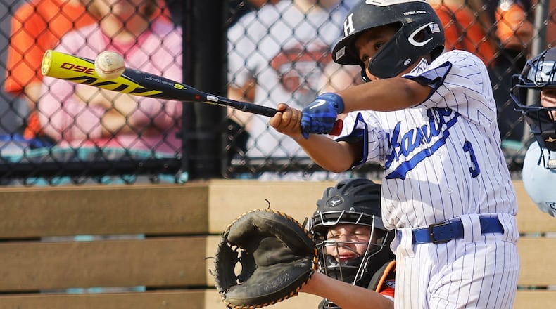 Hamilton's Sammy Platt makes contact with the ball during Hamilton West Side Little League's 10-1 win over Loveland in the District 9 Little League championship Monday, July 11, 2022 at Home of the Brave Park in Loveland. NICK GRAHAM/STAFF