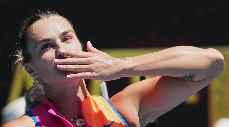 Aryna Sabalenka of Belarus celebrates after defeating Bai Zhuoxuan of China in their second round match at the Australian Open tennis championship in Melbourne, Australia, Wednesday, Jan. 21, 2026. (AP Photo/Dita Alangkara)