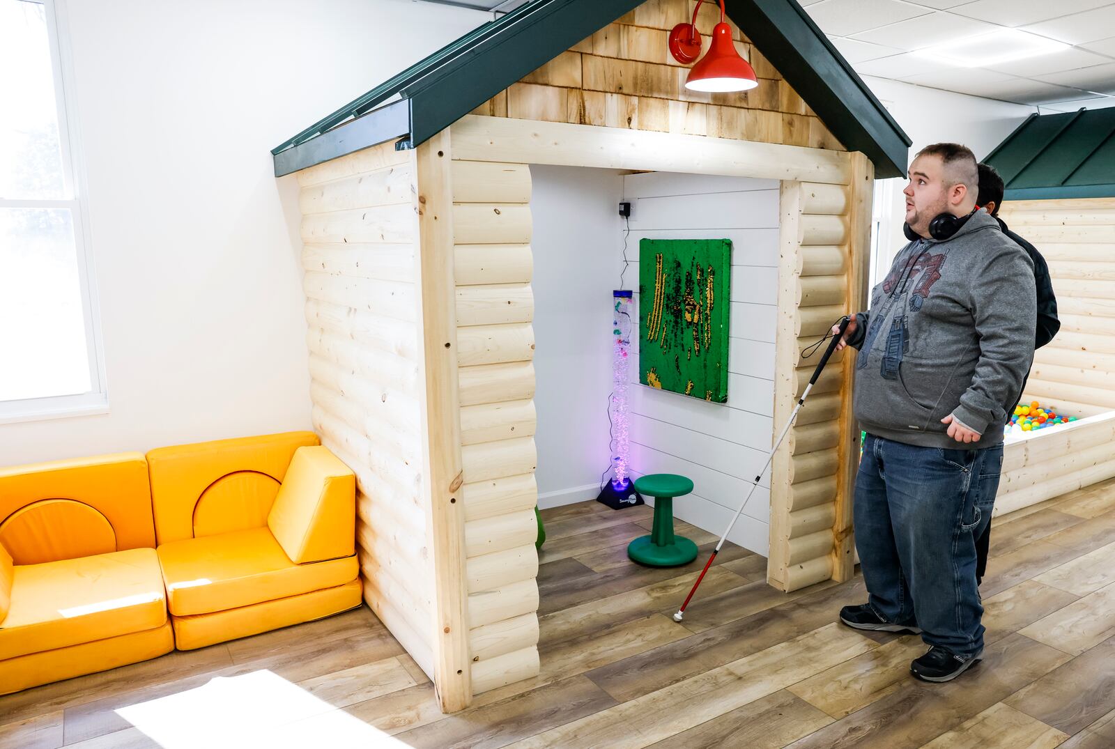 Tanner Davis, who is legally blind, explores Tanner's Tree House play area named in his honor during the opening of the Berachah Church's Compassion City Center on Friday morning. The playground was funded by a $5,000 donation and proceeds from the church's Master's Mission golf outing. NICK GRAHAM/STAFF