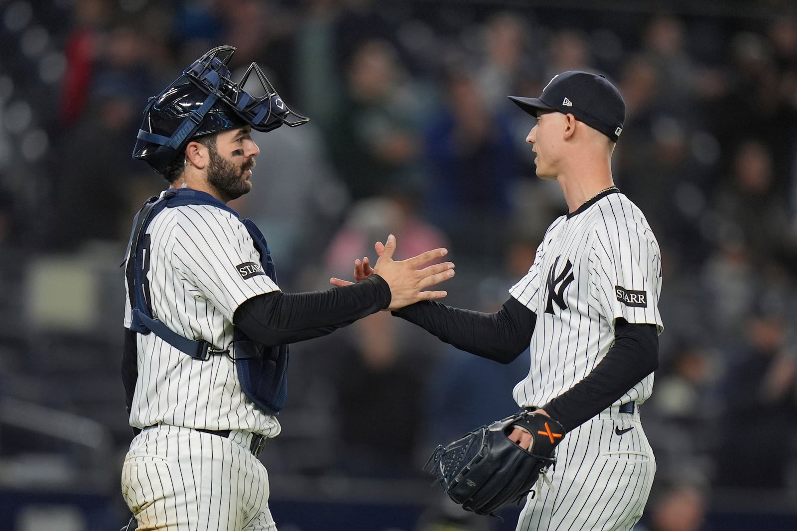 New York Yankees pitcher Luke Weaver, right, celebrates with catcher Austin Wells after a baseball game against the Texas Rangers Tuesday, May 20, 2025, in New York. (AP Photo/Frank Franklin II)
