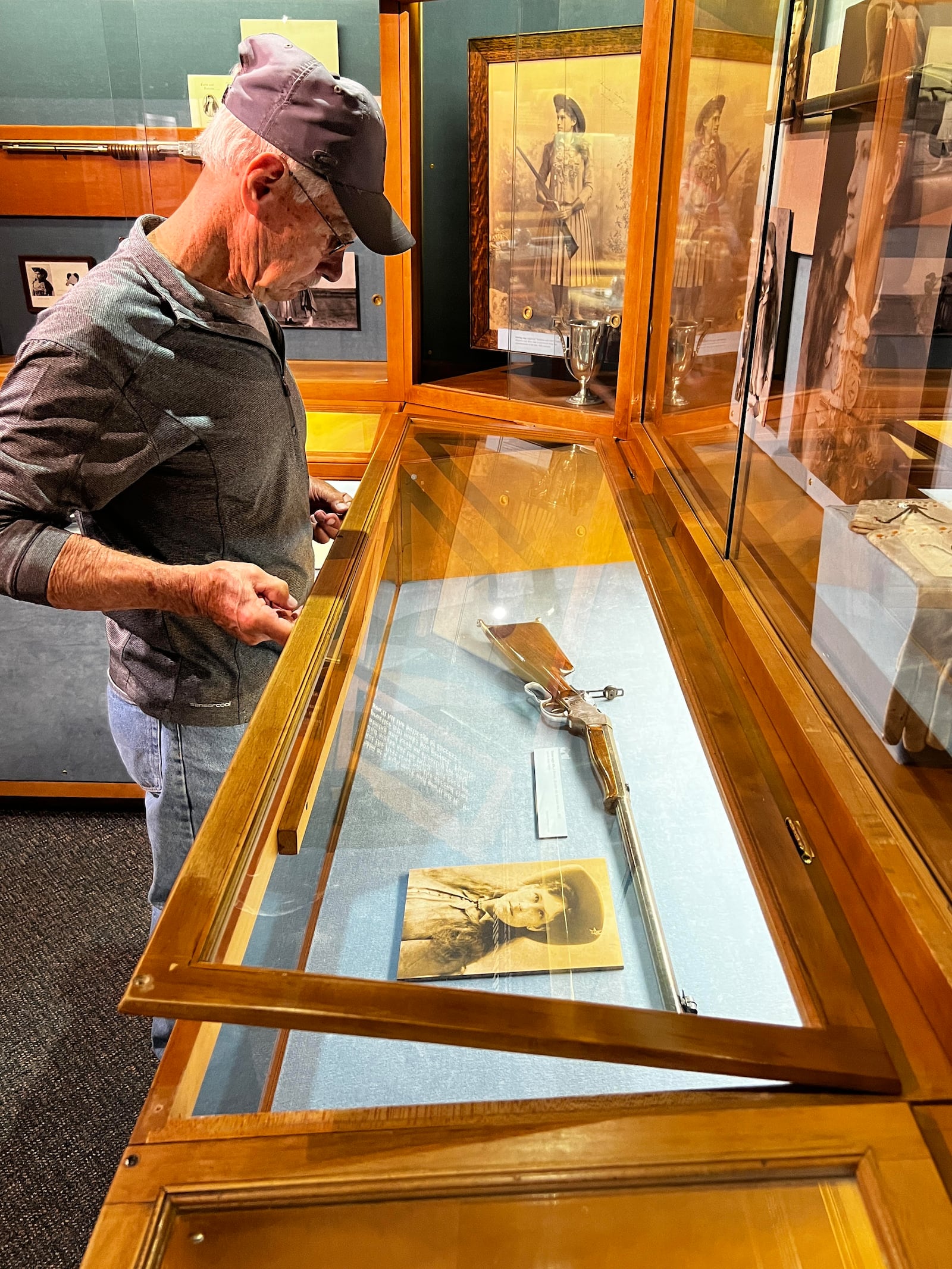 Dan Kagey, in his 66th year as the maintenance person at Garst, is shown removing the gun from its locked case for the "Hold Annie's Gun" event last year.
Contributed