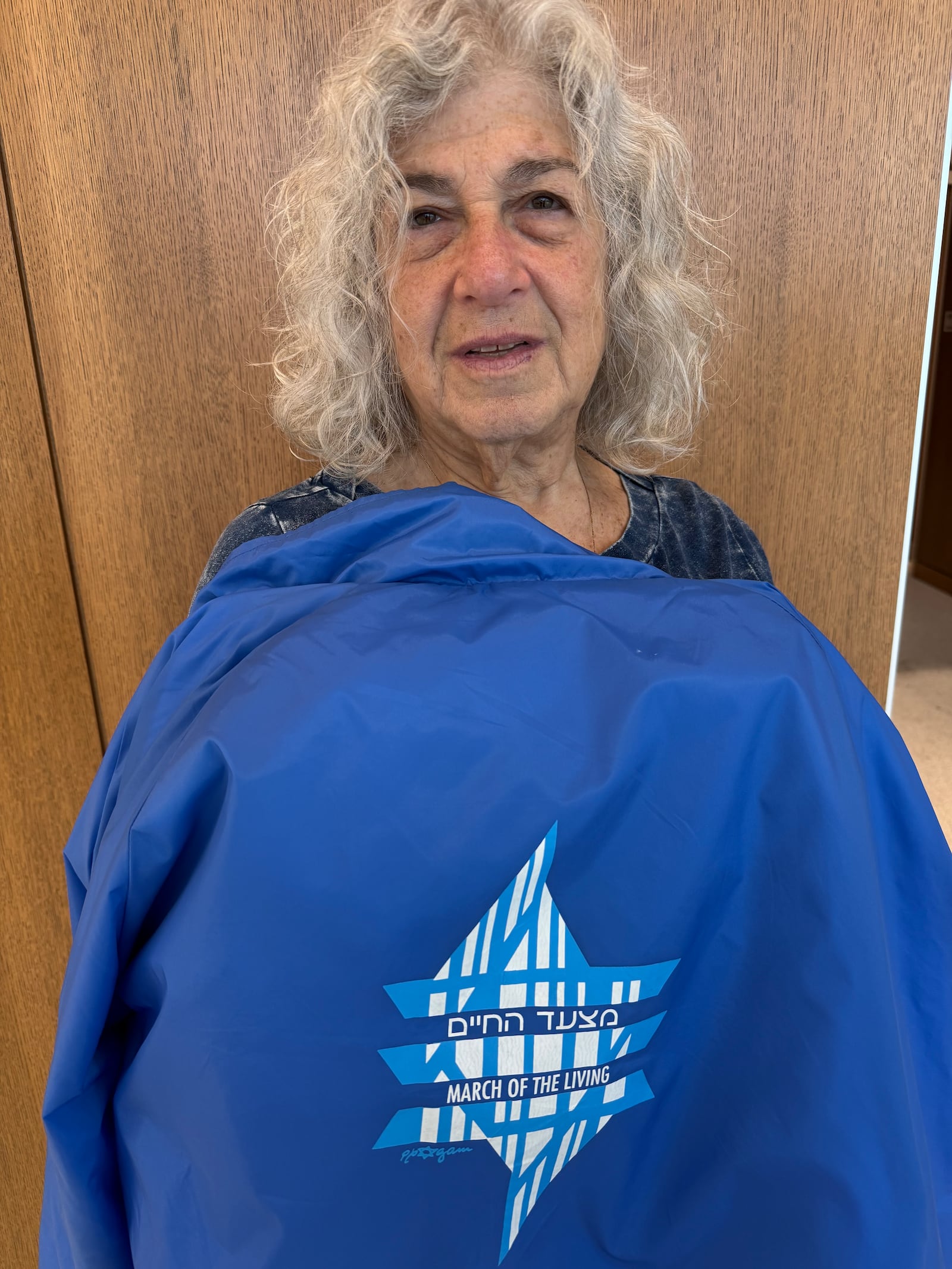 Helen Halcomb of Trotwood holds a jacket from the "March of the Living" she attended with her father and sisters. MARC JACOB/CONTRIBUTED