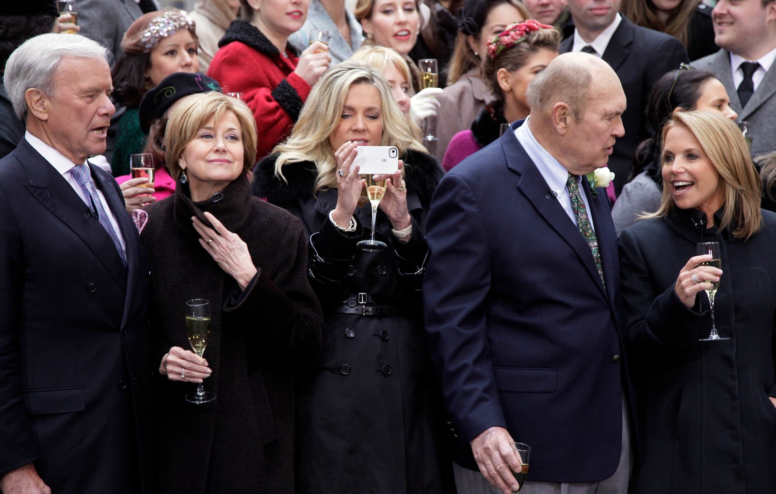 FILE - Former NBC "Today" television program hosts Tom Brokaw, left, Jane Pauley, second left, Deborah Norville, center, and Katie Couric, right, with veteran weatherman Willard Scott, gather for a toast in New York's Rockefeller Center, Jan. 13, 2012. (AP Photo/Richard Drew, File)