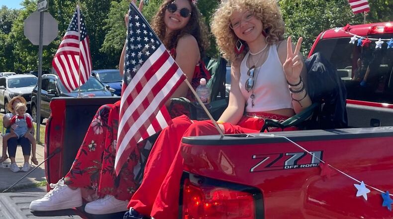 Marie, left, and Macie Cunningham, from Hamilton, singing sisters who have performed on national television, ride in the Hamilton 4th of July Parade on Mon., July 4, 2022. The parade traveled from the Butler Co. Fairgrounds to Dayton Street, Seventh Street, High and Main streets, ending at F Street. STAFF PHOTOS