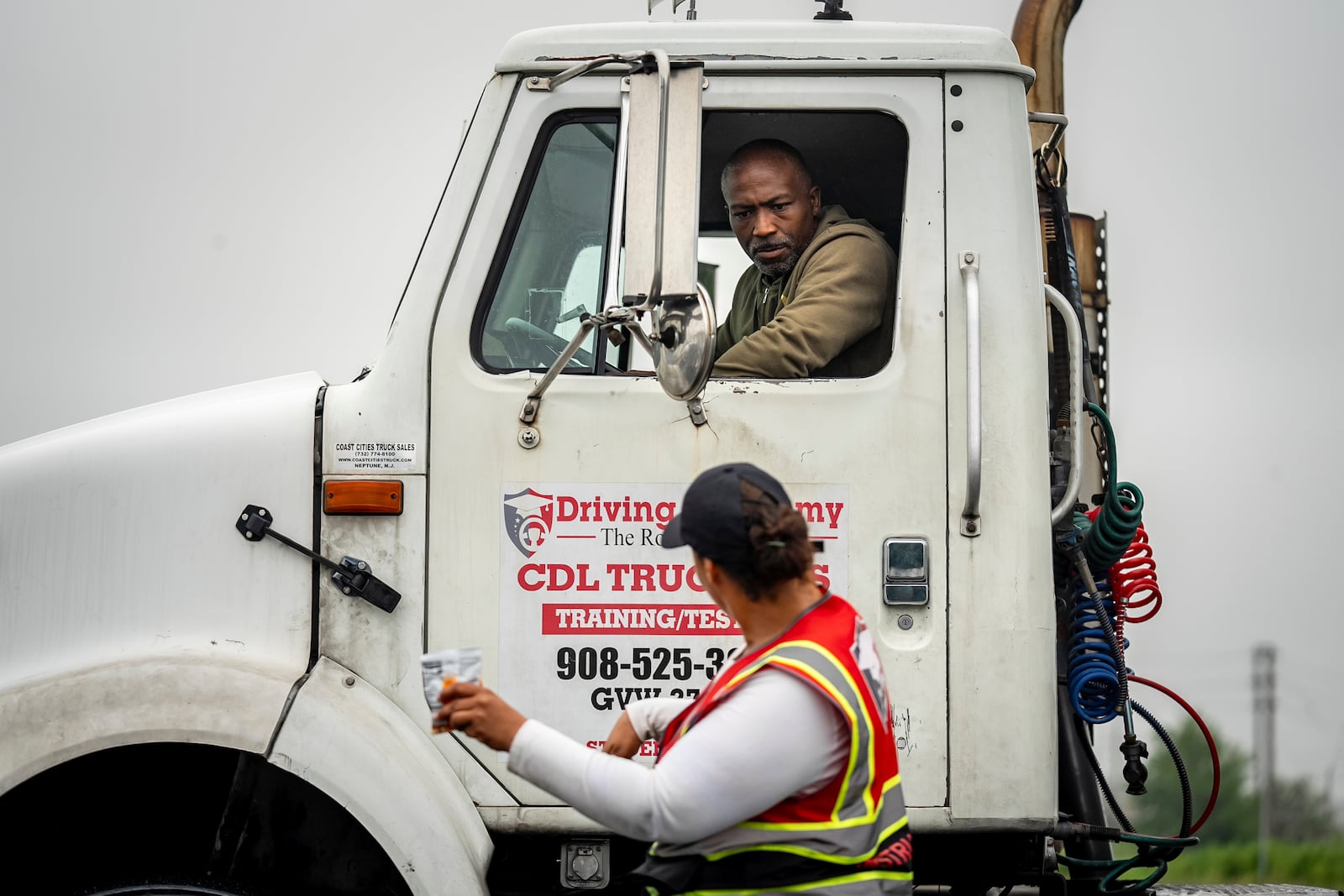 An instructor provides reverse parking advice to a student at the Driving Academy on Tuesday, June 10, 2025 in Linden, N.J., where students prepare to obtain a Commercial Driver’s License (CDL) with multilingual instructors.(AP Photo/Angelina Katsanis)