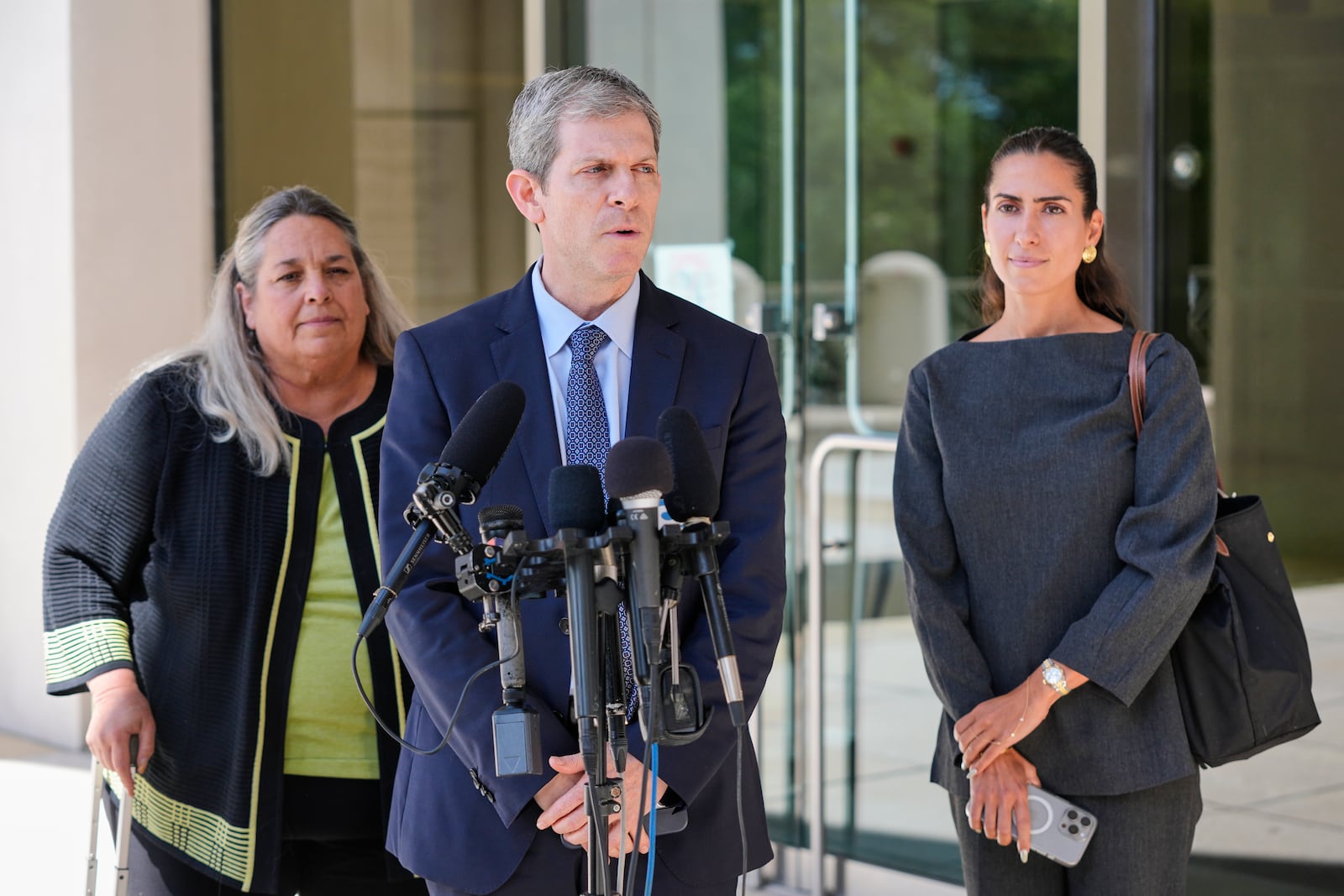 David Oscar Markus, attorney for Ghislaine Maxwell, center, speaks during a news conference outside the federal courthouse in Tallahassee, Fla., Thursday, July 24, 2025. Behind him is Leah Saffian, co-attorney, left, and Mellissa Madrigal, right. (AP Photo/John Raoux)