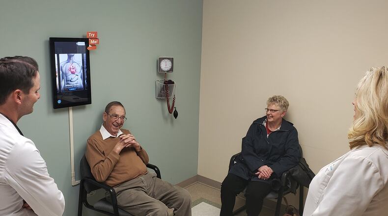 Dr. Daniel Eckert (left), a cardiologist with Mercy Health-The Heart Institute, and TAVR program coordinator Jami Heil (right) speak with Thomas and Philomena Banks during a follow-up appointment at Mercy Health-Fairfield Hospital Thursday, Dec. 19, 2019. Thomas Banks was the 300th person to undergo a transcatheter aortic valve replacement, or TAVR, a low-risk procedure that allows patients to be discharged within 24 hours, with complete recovery in less than a week. ERIC SCHWARTZBERG/STAFF
