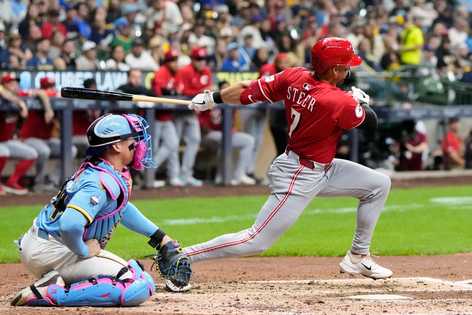 Cincinnati Reds' Spencer Steer hits an RBI single during the fourth inning of a baseball game against the Milwaukee Brewers Friday, Sept. 26, 2025, in Milwaukee. (AP Photo/Morry Gash)