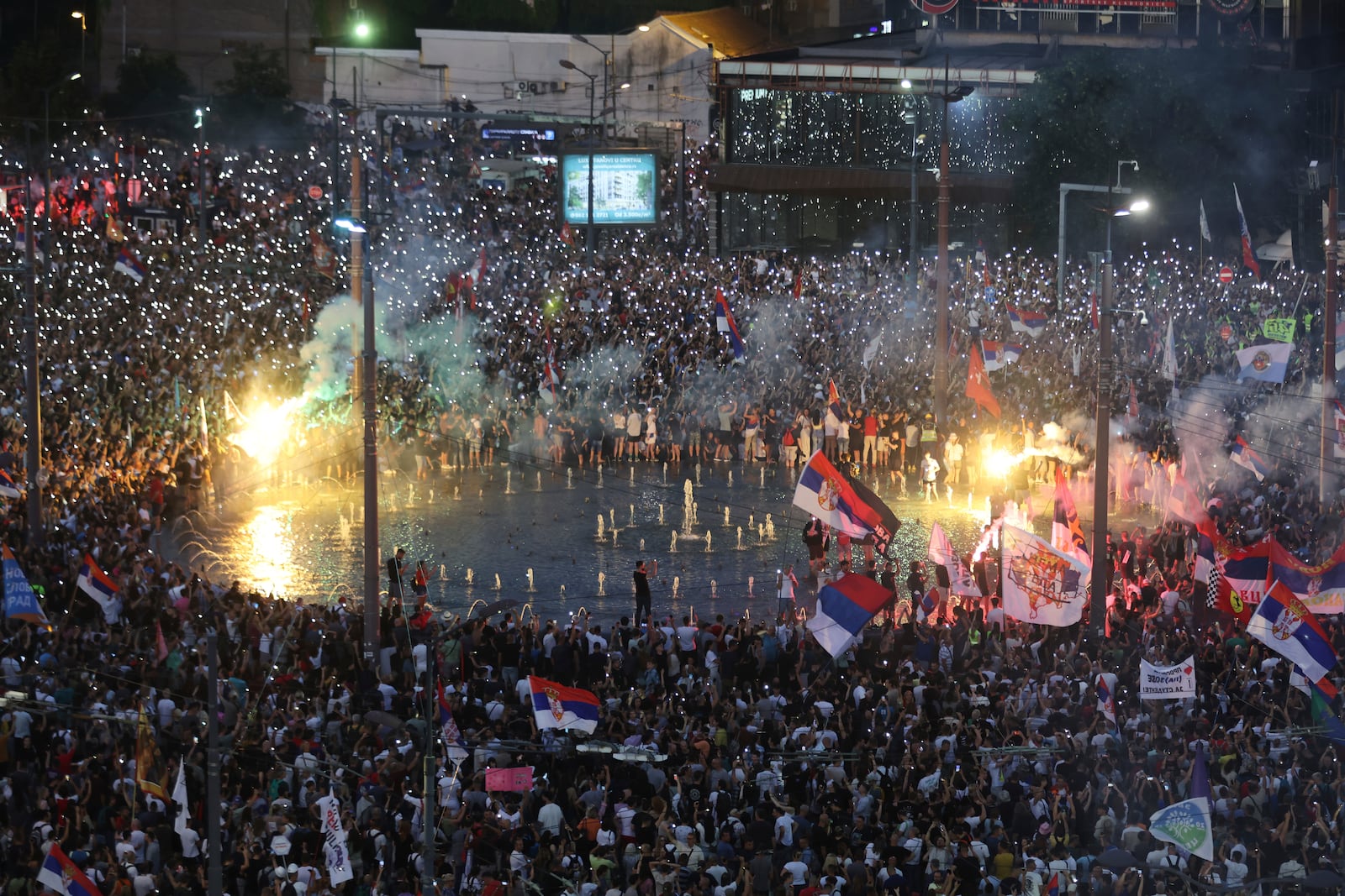 People wave their mobile phones with flashing lights during a major anti-government rally in Belgrade, Serbia, Saturday, June 28, 2025. (AP Photo/Marko Drobnjakovic)