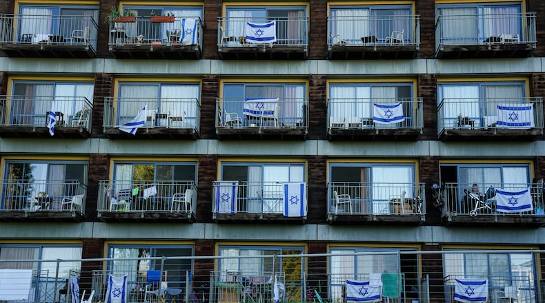 FILE - Israeli flags decorate rooms of Israelis who evacuated from cities and towns along the border with Lebanon, in kibbutz Ginosar hotel, northern Israel, Tuesday, March 5, 2024. (AP Photo/Ariel Schalit, file)