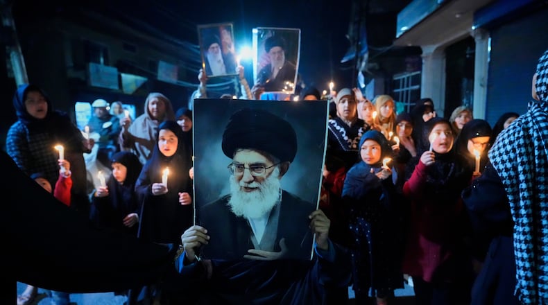Shiite Muslims shout slogans during a candlelit protest against the killing of Iran's Supreme Leader Ayatollah Ali Khamenei, in Srinagar, Indian controlled Kashmir, Wednesday, March 4, 2026. (AP Photo/Mukhtar Khan)