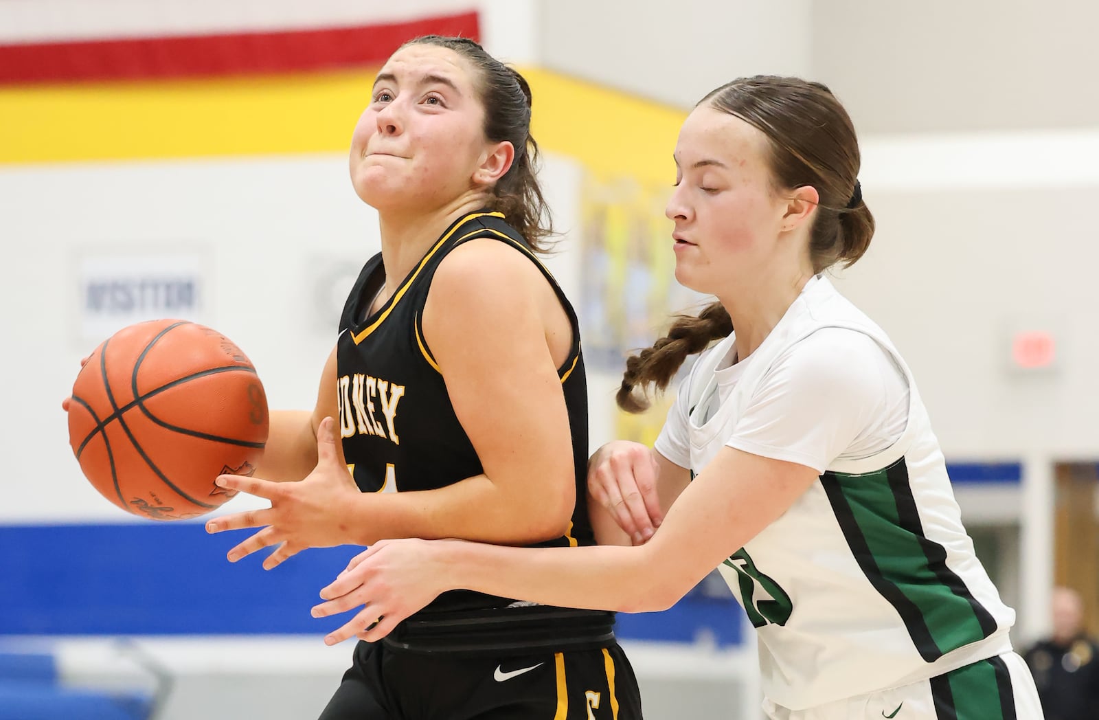 Sidney senior guard Jada Shroyer (left) dribbles with pressure from Greenville's Megan Loudy during a Division III district quarterfinal on Friday, Feb. 20 at Springfield High School. Shroyer scored seven points. BRYANT BILLING / STAFF