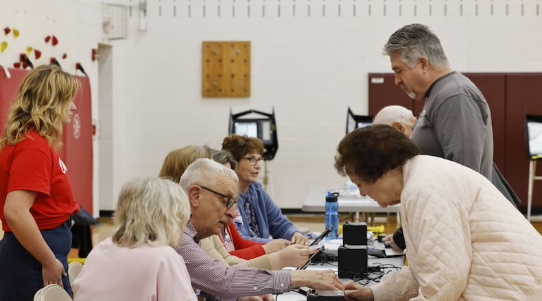 Poll workers check in residents to vote at Elda Elementary School Tuesday, May 2, 2023 in Ross Twp. Residents were voting on a levy for Ross schools. NICK GRAHAM/STAFF