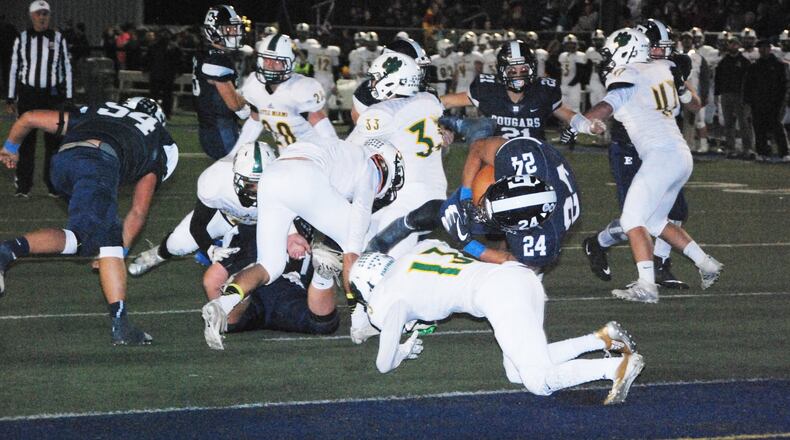 Edgewood’s Elijah Williams (24) goes over Little Miami’s Ryan Kerman and into the end zone for a first-quarter touchdown Friday night at Kumler Field in St. Clair Township. The host Cougars won 20-0. CONTRIBUTED PHOTO BY OLIVER SANDERS