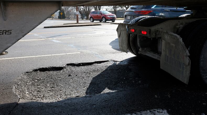 A large pothole on Dryden Road near Main Street in Moraine. MARSHALL GORBY\STAFF