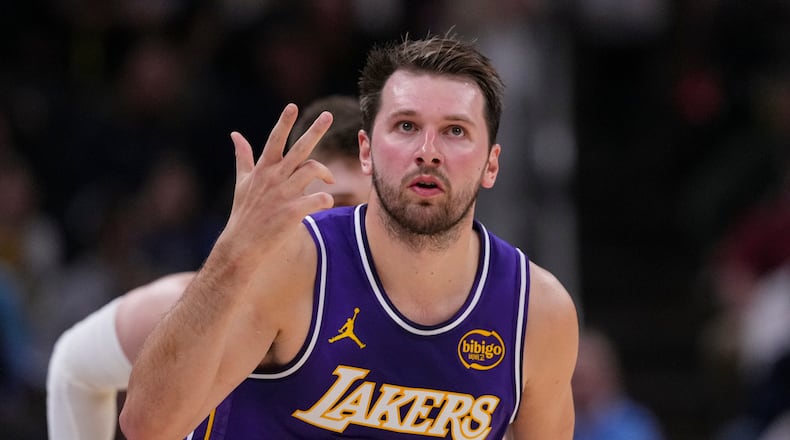 Los Angeles Lakers guard Luka Doncic (77) gestures after a three-point basket against the Indiana Pacers during the first half of an NBA basketball game in Indianapolis, Wednesday, March 25, 2026. (AP Photo/Michael Conroy)