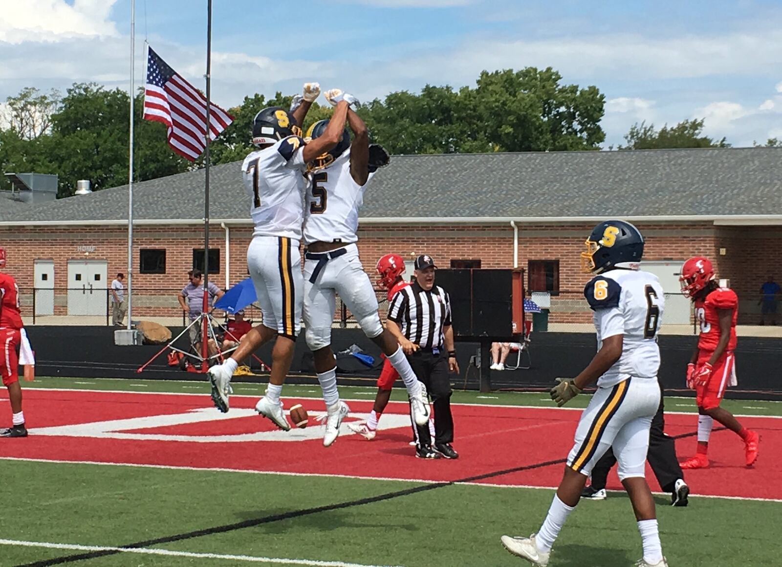 Springfield’s Larry Stephens (5) and Michael Brown-Stephens (7) celebrate a late touchdown catch by Stephens on Saturday afternoon against Fairfield at Fairfield Stadium. The Wildcats then made a two-point conversion to win 15-14. RICK CASSANO/STAFF