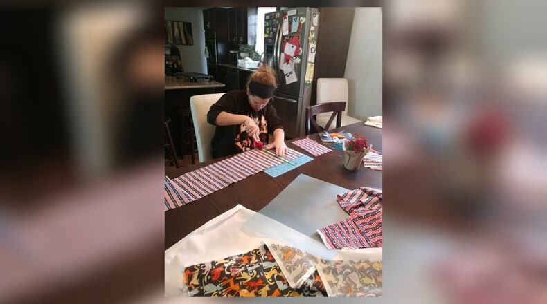 Gianna Frongia, an eighth-grader at John XXIII School, makes a mask that will be donated Friday to Atrium Medical Center. Students in a youth art program made 375 masks for AMC and will make more for local nursing home workers. SUBMITTED PHOTO