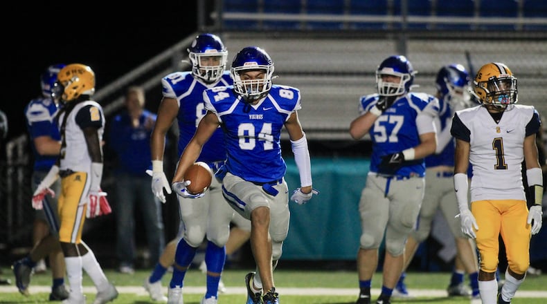 Miamisburg's Jackson McGohan celebrates the first of his three touchdowns against Springfield on Friday, Oct. 15, 2021, at Holland Field in Miamisburg. David Jablonski/Staff