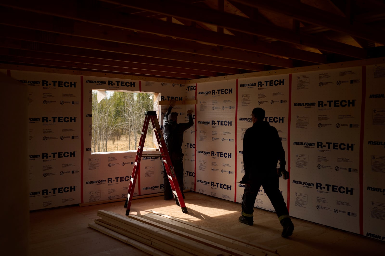Joe Cleaver II, left, and Derrick Esmailka build an energy efficient home Thursday, May 22, 2025, in Galena, Alaska. (AP Photo/John Locher)