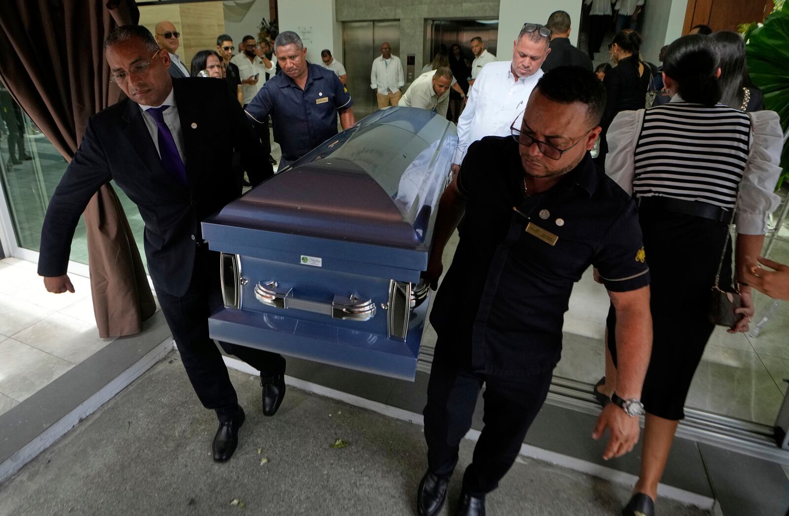 Funeral home personnel move the casket of Octavio Dotel, a former MLB baseball player who died at the Jet Set nightclub where more than 200 people were killed when its roof collapsed, in Santo Domingo, Dominican Republic, Thursday, April 10, 2025. (AP Photo/Matias Delacroix)