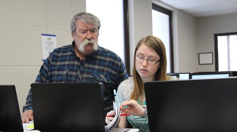 Clark County Board of Elections' employees, including seasonal workers, perform logic and accuracy tests on voting equipment Friday morning as early voting in Ohio is slated to start on Tuesday. Hasan Karim/Staff