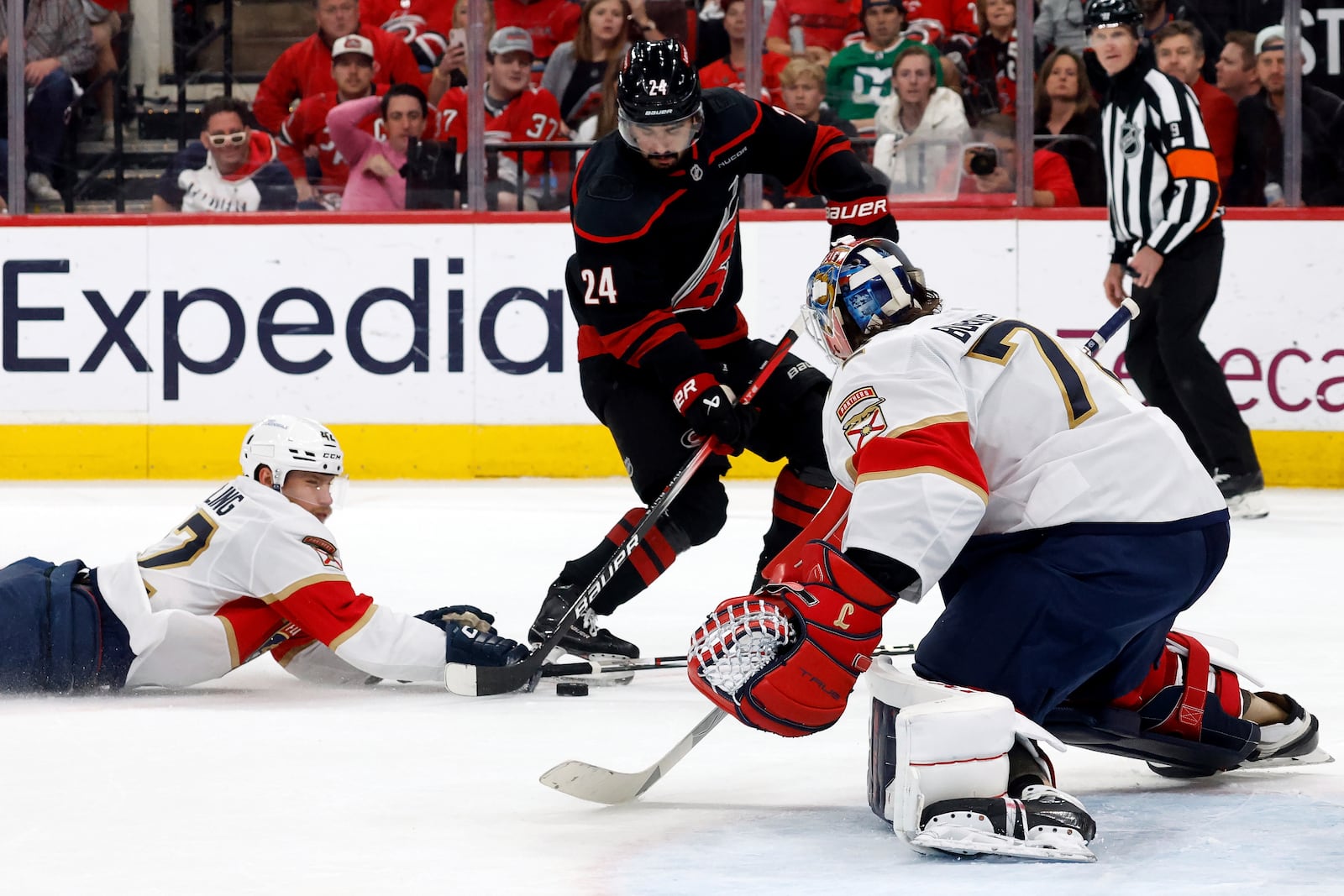 Carolina Hurricanes' Seth Jarvis (24) is prevented from shooting the puck by Florida Panthers' Gustav Forsling (42) as goaltender Sergei Bobrovsky (72) looks on during the second period of Game 2 of the NHL hockey Stanley Cup Eastern Conference finals in Raleigh, N.C., Thursday, May 22, 2025. (AP Photo/Karl DeBlaker)