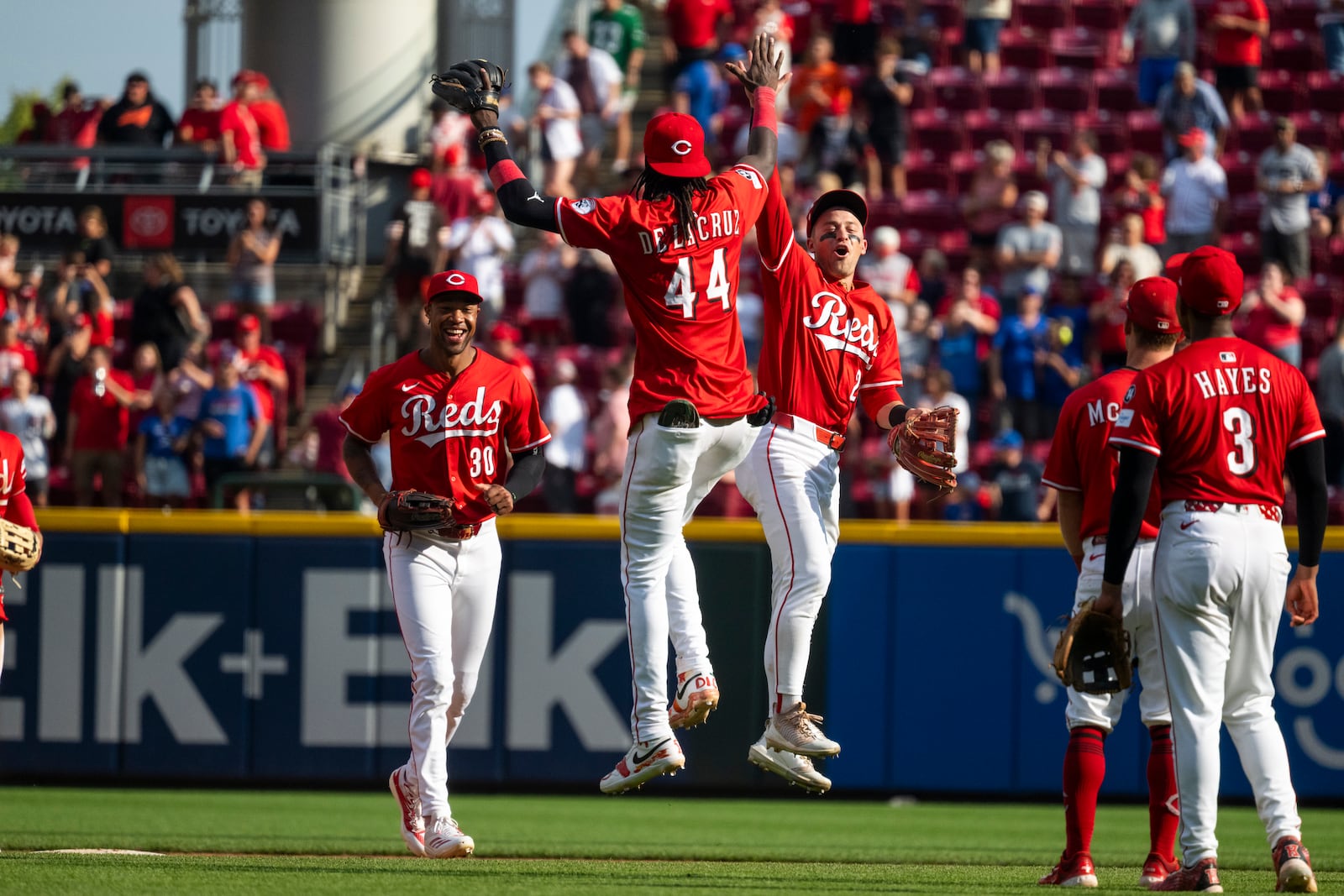 Cincinnati Reds shortstop Elly De La Cruz (44) and outfielder TJ Friedl (29) high-five after defeating the Chicago Cubs, Sunday, Sept. 21, 2025, in Cincinnati. (AP Photo/Michael Swensen)