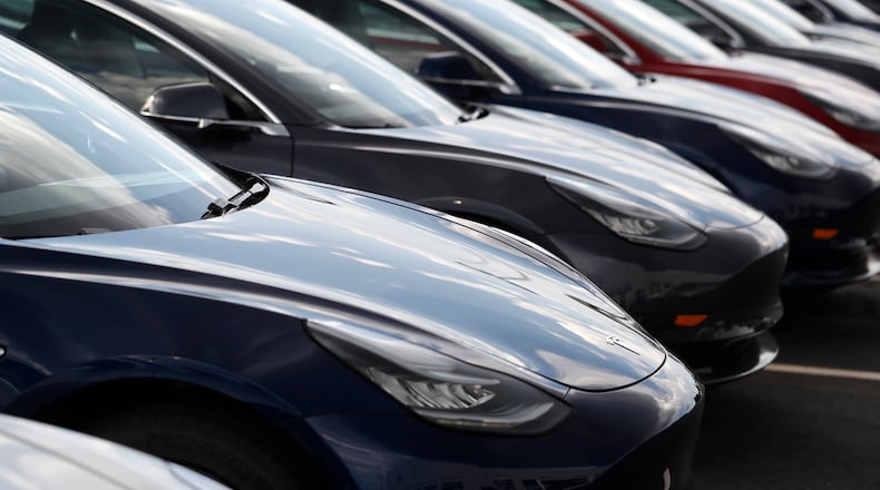 FILE - Several 2018 Model 3 sedans sit on display outside a Tesla showroom, July 8, 2018, in Littleton, Colo. (AP Photo/David Zalubowski, File)