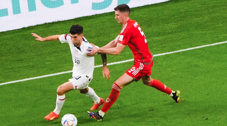 U.S. forward Christian Pulisic (10) and Wales defender Chris Mepham (5) during the first half of a World Cup soccer match between the U.S. and Wales at Ahmad Bin Ali Stadium in Doha, Qatar, on Monday, Nov. 21, 2022. (Erin Schaff/The New York Times)