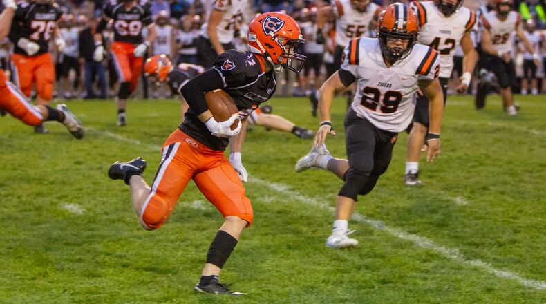 Coldwater receiver Braylen Harlamert runs for a first down against Versailles Friday night at Coldwater. Jeff Gilbert/CONTRIBUTED