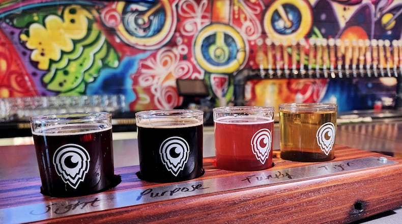 Third Eye Brewing on Dixie Highway in Hamilton has beer flight boards made with wood salvaged from the building during its construction. NICK GRAHAM/STAFF