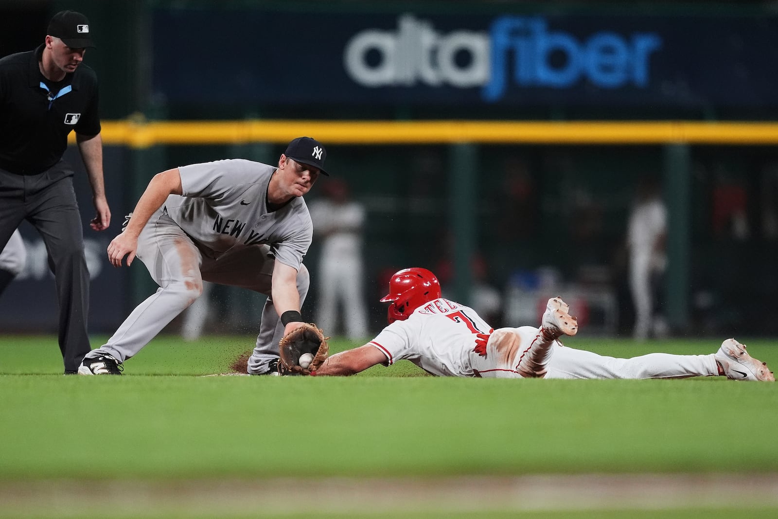 Cincinnati Reds' Spencer Steer, right, steals second base as New York Yankees second baseman DJ LeMahieu, second from left, misses the tag during the eighth inning of a baseball game, Monday, June 23, 2025, in Cincinnati. (AP Photo/Joshua A. Bickel)