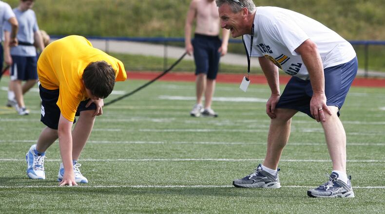 Monroe coach Brett Stubbs runs players through sprints during the first conditioning session of the summer on June 8, 2010, at Monroe. NICK GRAHAM/STAFF