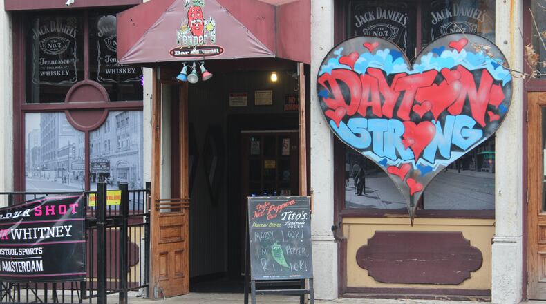 Six months after a 24-year-old Bellbrook man killed nine people in the Oregon District during the worst mass shooting in Ohio history, literal signs of strength, appreciation, resilience and the determination to “do something” about gun violence can be found throughout the historic neighborhood. "The Dayton Strong" sign hangs outside of Ned Peppers. AMELIA ROBINSON/STAFF