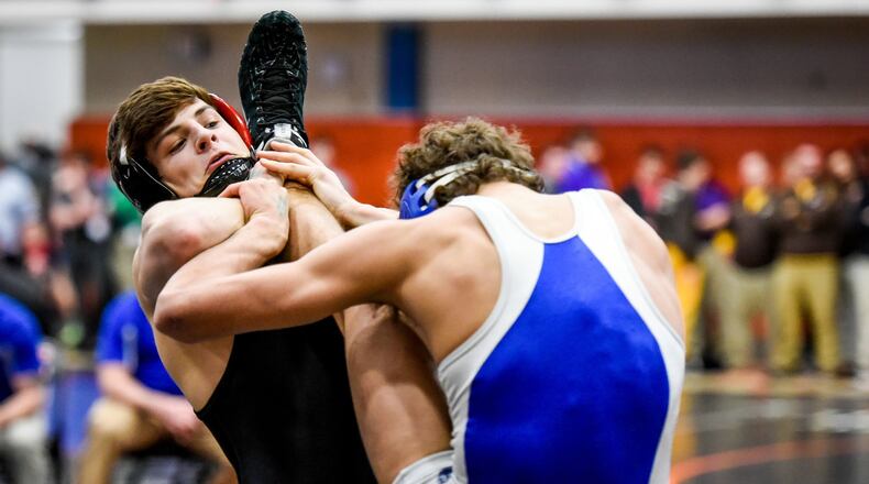 Franklin’s Trenten Scott (left) gets the win over Washington Court House’s Zane Nelson during their match in the 145-pound weight class at the Division II district wrestling tournament March 3 at Wilmington. NICK GRAHAM/STAFF