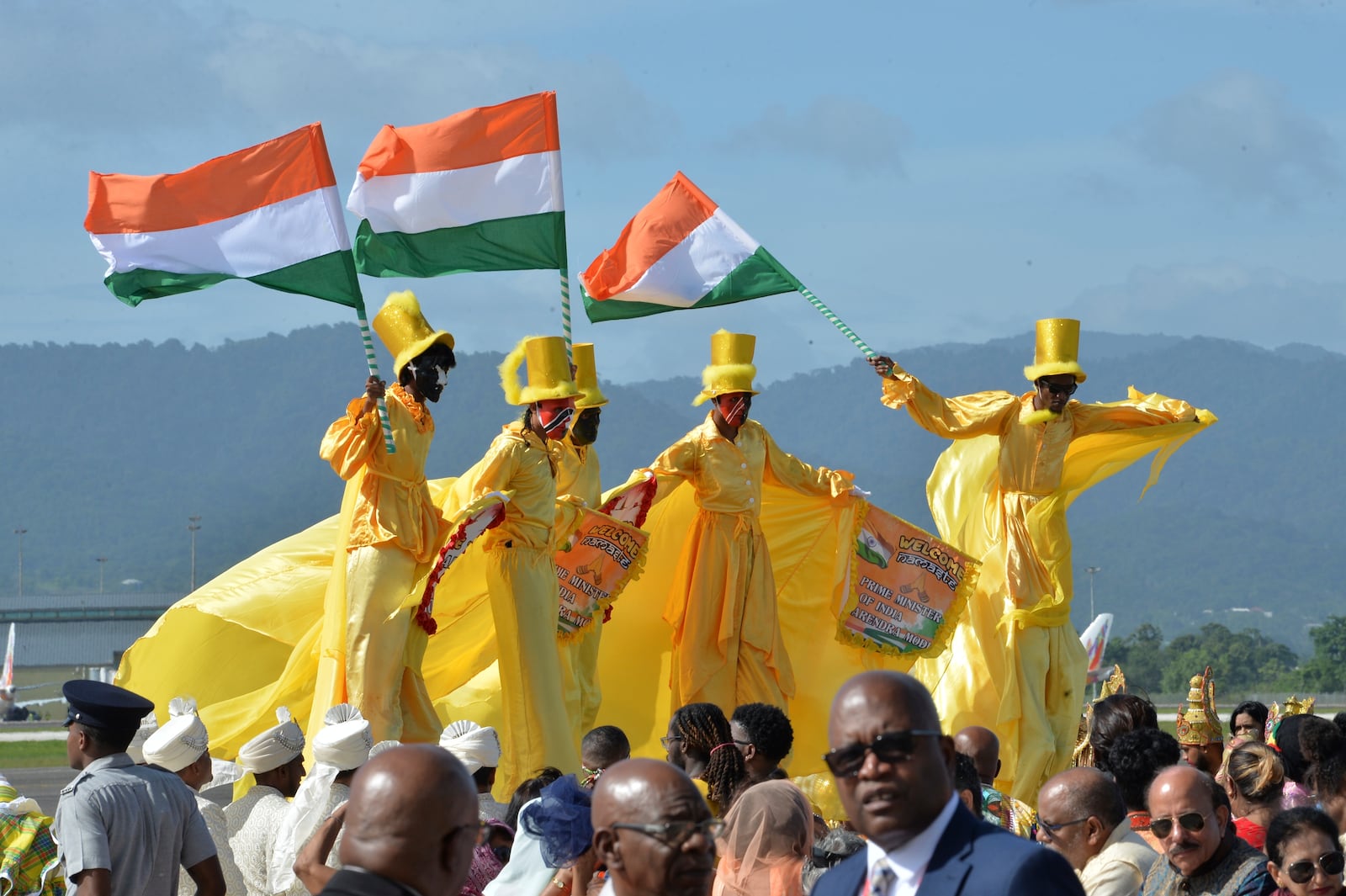 Moko Jumbies wave Indian flags during Indian Prime Minister Narendra Modi's arrival at Piarco International Airport in Piarco, Trinidad and Tobago, Thursday, July 3, 2025. (AP Photo/Jermaine Cruickshank)