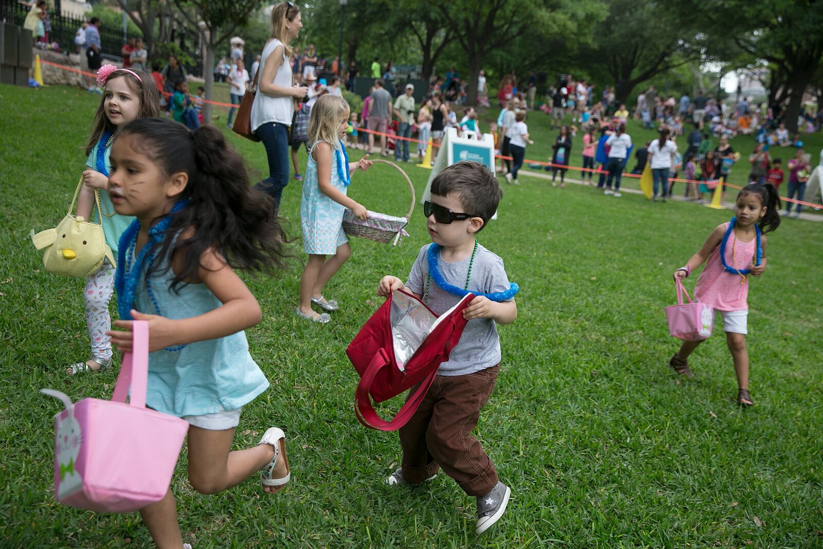 Children, including Max Voltron, 4, center, run across the grass in search of eggs during the egg hunt at the First United Methodist Church's annual Easter egg hunt on the grounds of the state Capitol on Saturday, April 15, 2017.  Food was sold at the event with proceeds supporting First UMC's Eurasia Mission Team, and non-perishable food donations were taken for the Capital Area Food Bank. DEBORAH CANNON / AMERICAN-STATESMAN