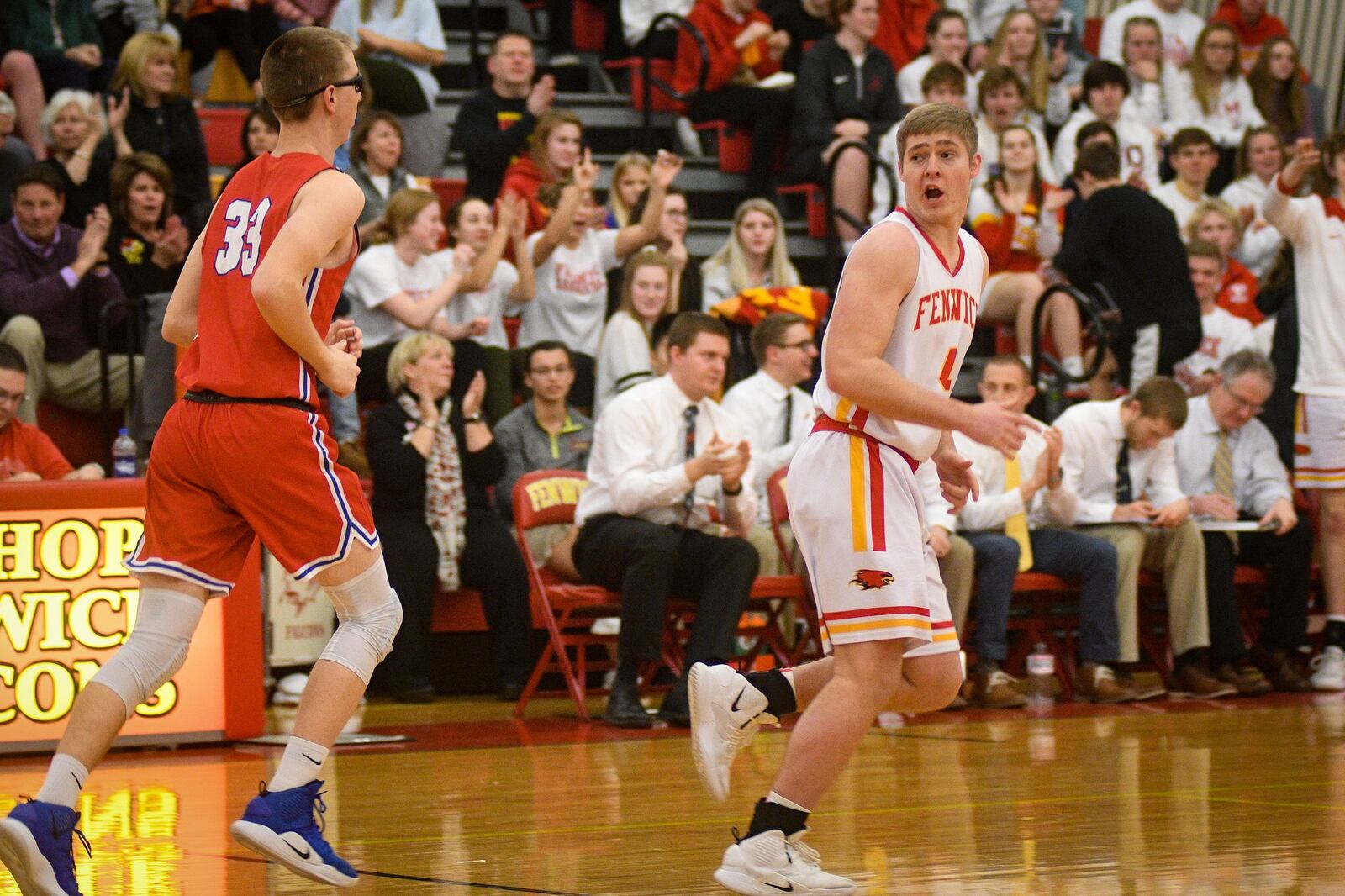 Fenwick’s Thomas Vogelsang (4) and Clinton-Massie’s Drew Settlemyre (33) head down the floor during Monday night’s game at Fenwick. The host Falcons won 67-48. ROB MCCULLEY/RAM PHOTOGRAPHY